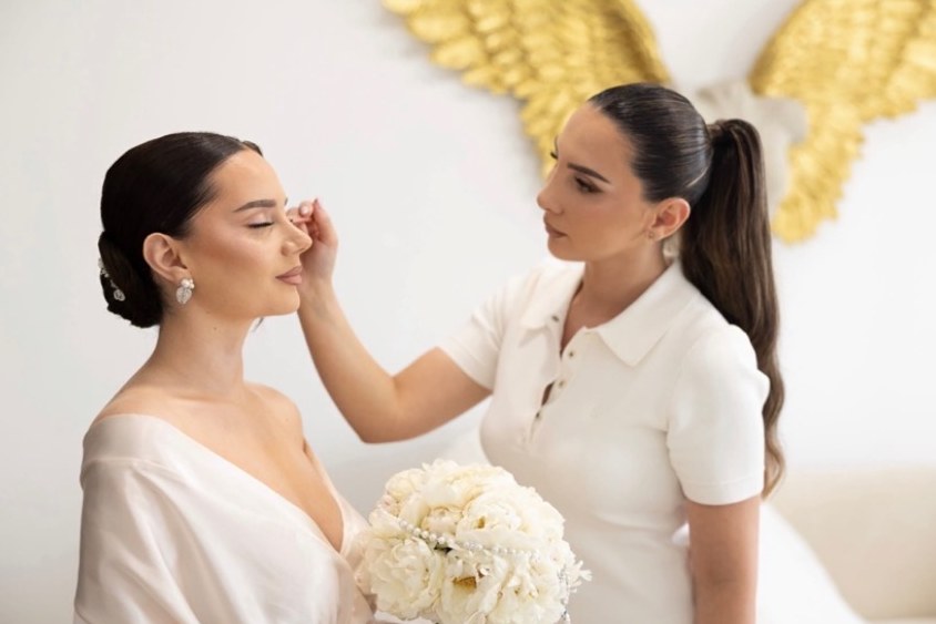 Makeup artist Dea Gjini doing a bride’s makeup